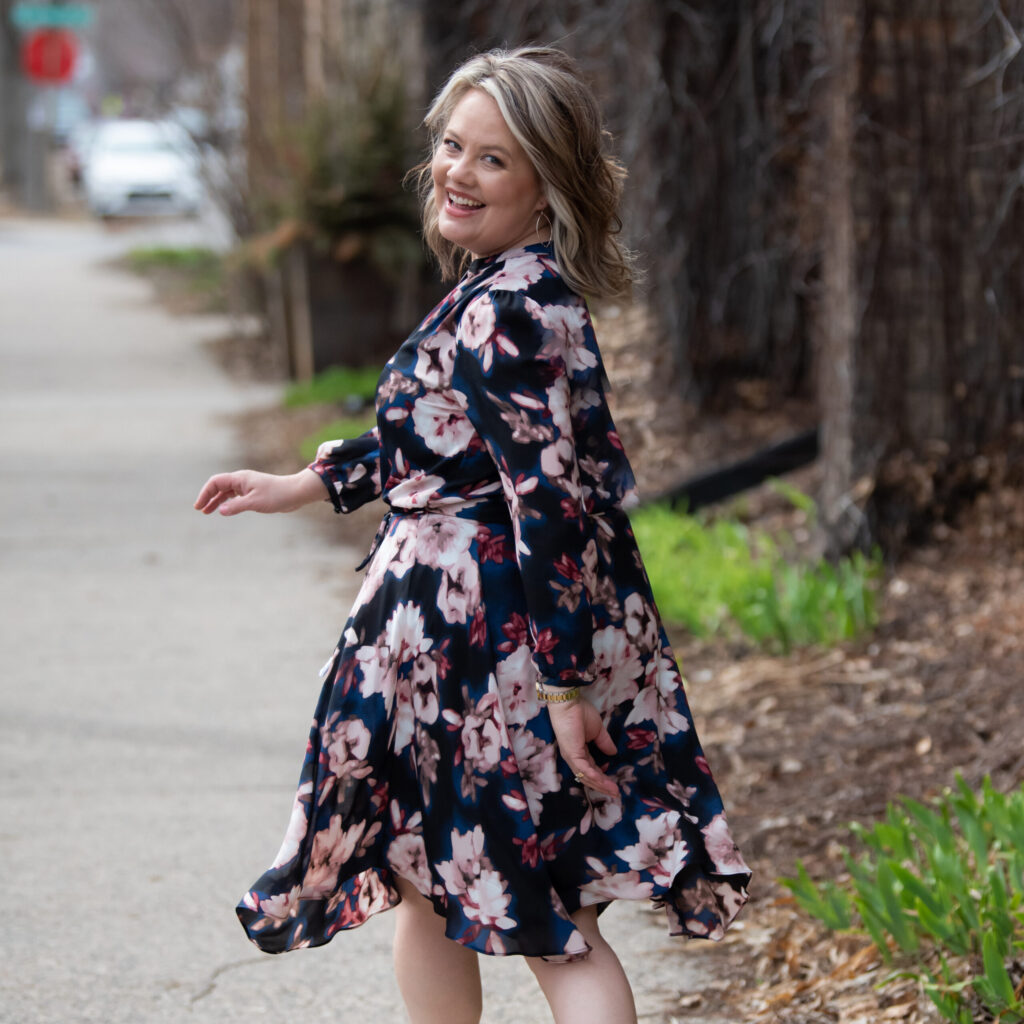 Tammy Krings, leadership coach and Everything DiSC facilitator Walking down sidewalk full of live