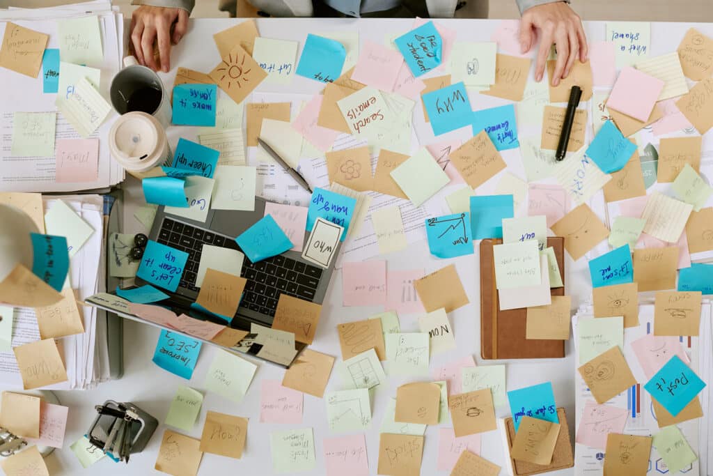 Are We Asking Managers to Carry Too Much? 1 Cluttered desk with colorful sticky notes